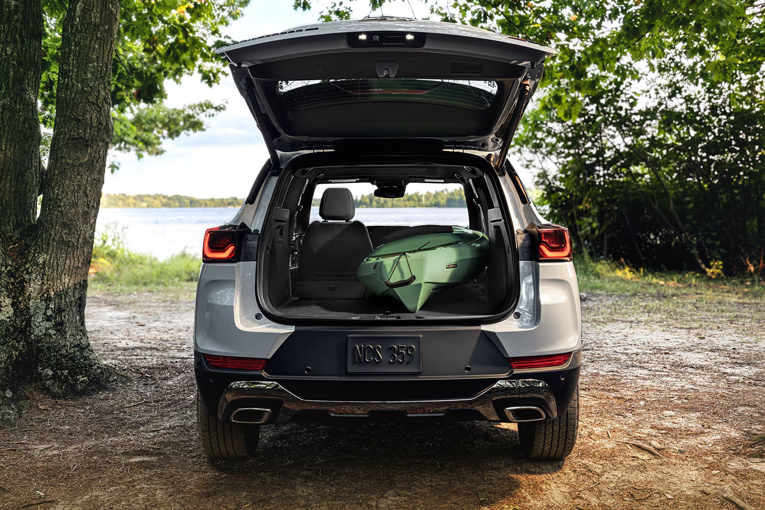 Rear view of a 2027 Chevrolet Trailblazer with the liftgate open, showcasing the cargo area with a duffel bag inside.