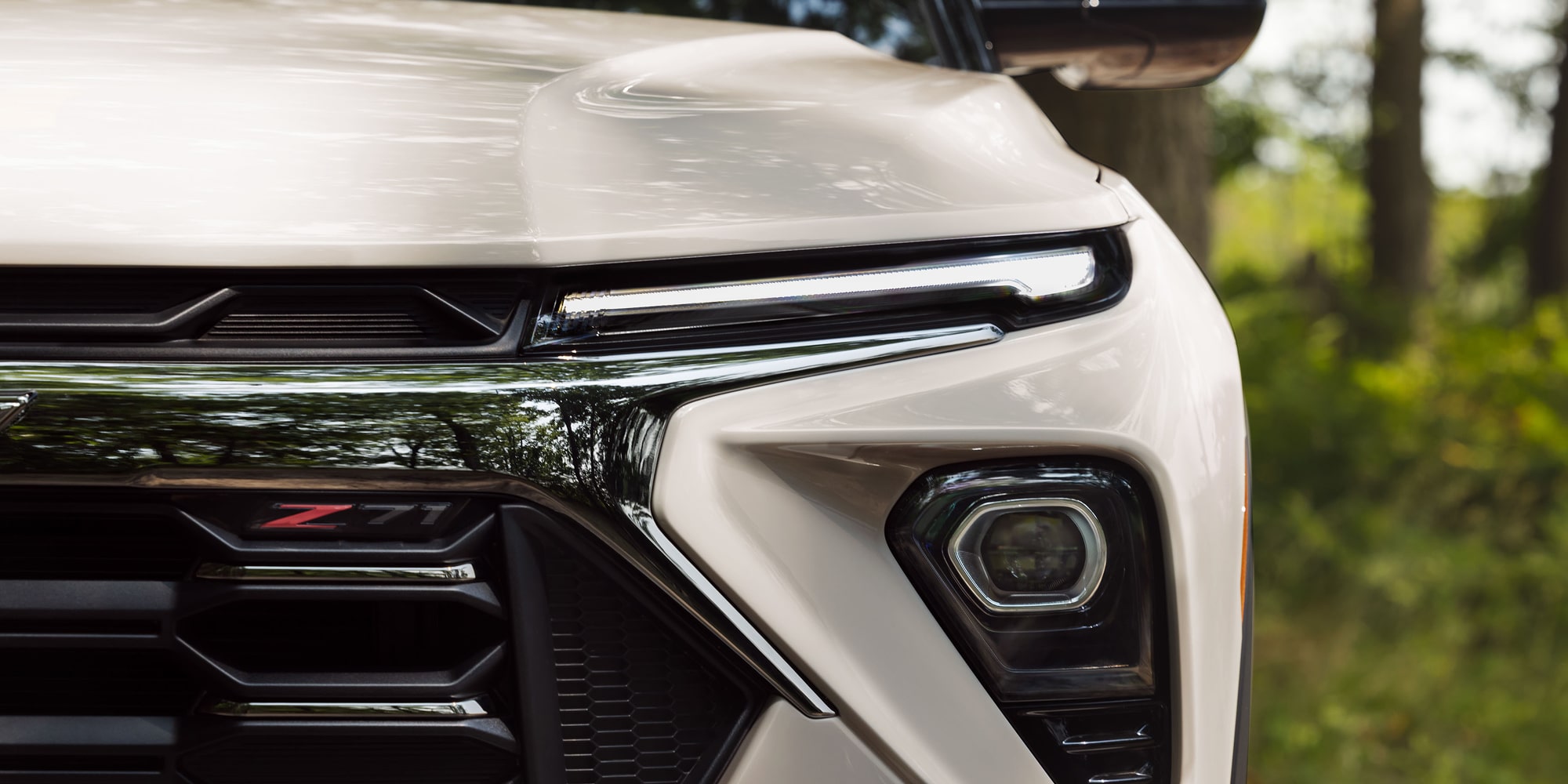 Close-up of the front fascia of a white 2027 Chevrolet Trailblazer Z71.
