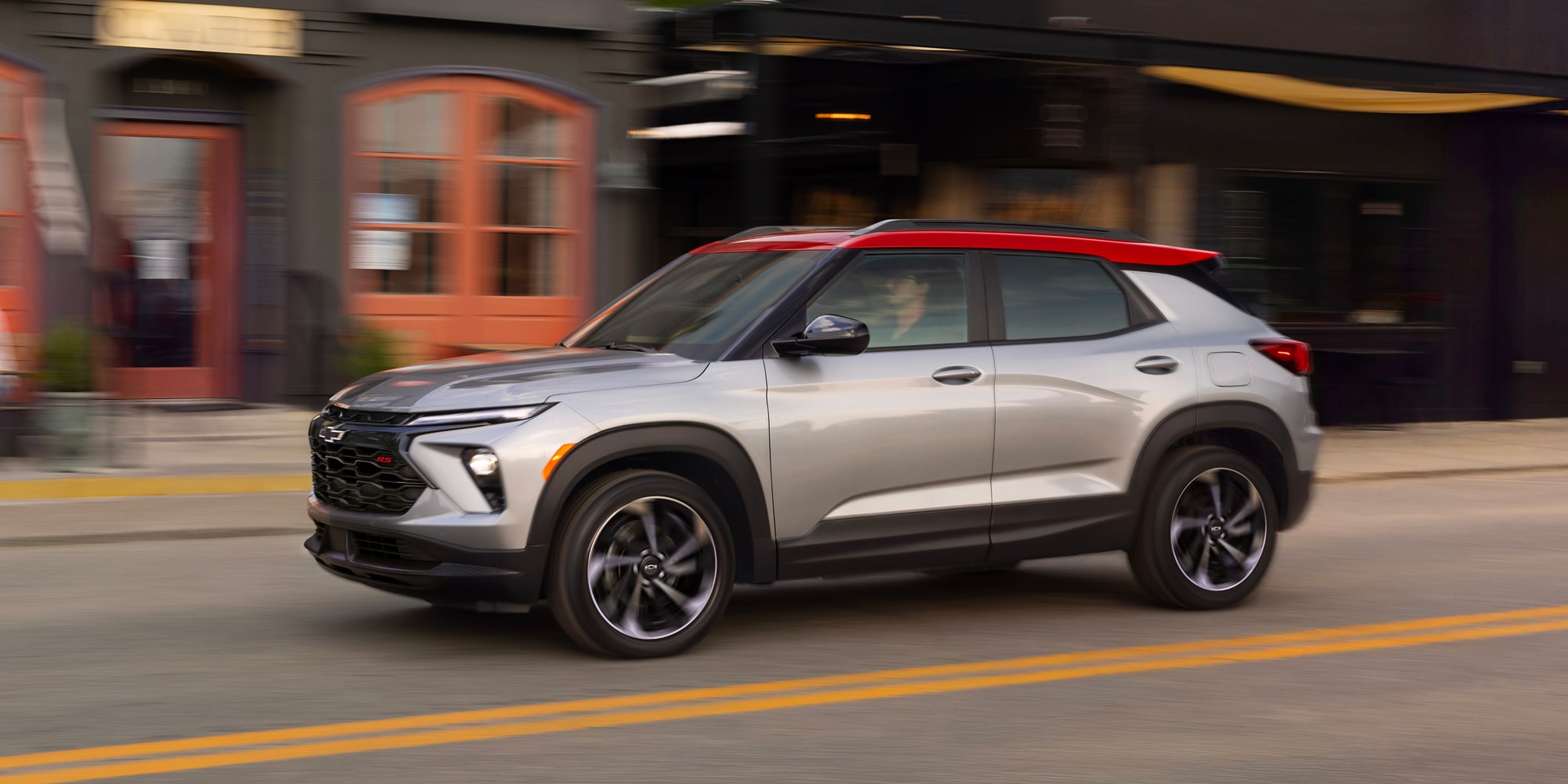 2027 Chevrolet Trailblazer RS driving through a city street.