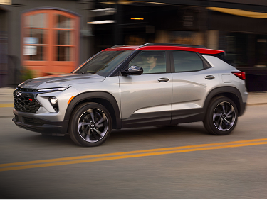 Front three-quarter view of a 2027 Chevrolet Trailblazer driving on a city street.
