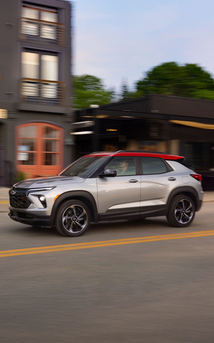 Side view of the 2027 Chevrolet Trailblazer driving through an urban street.