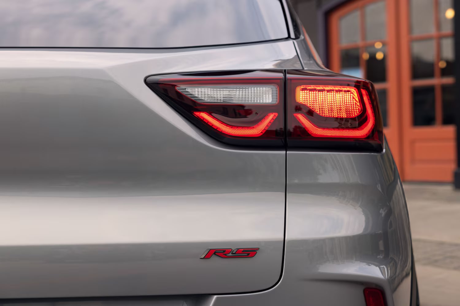 Close-up of the rear corner of a 2027 Chevrolet Trailblazer, highlighting the illuminated LED taillight design.