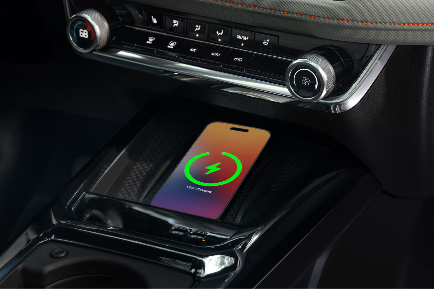 Wireless charging pad in the 2027 Chevrolet Trailblazer center console charging a smartphone, with climate controls and dashboard trim visible above.