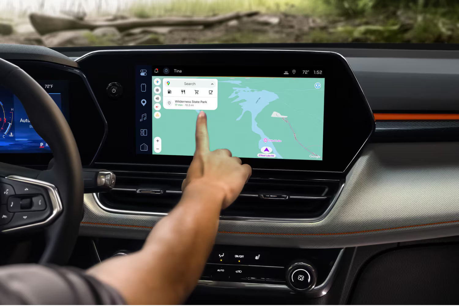 Person interacting with the 2027 Chevrolet Trailblazer infotainment touchscreen displaying a navigation map.