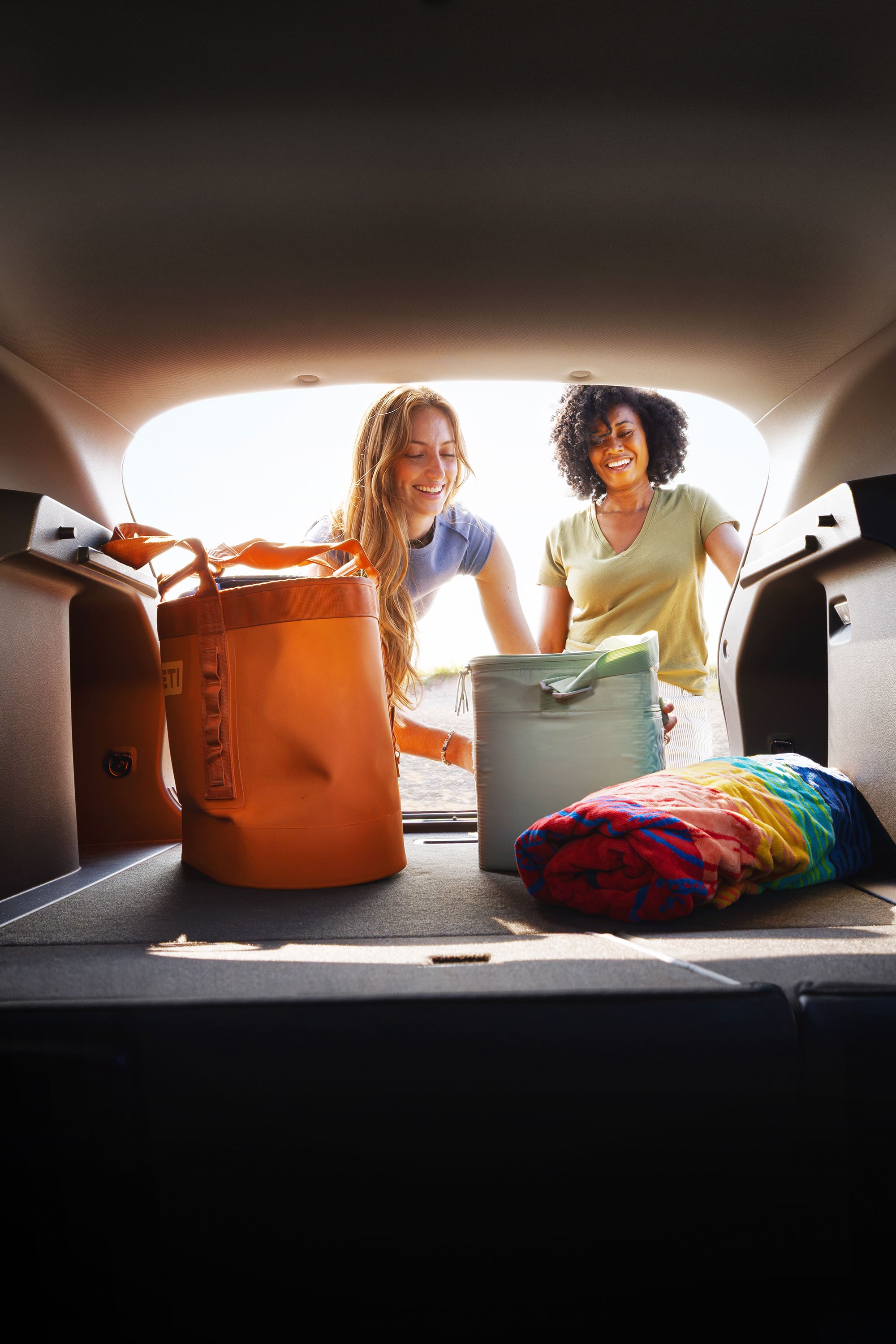 View from the rear cargo area of the 2027 Chevrolet Trax small SUV showing luggage and travel bags loaded in the cargo space, highlighting versatile storage capacity for everyday adventures and road trips..