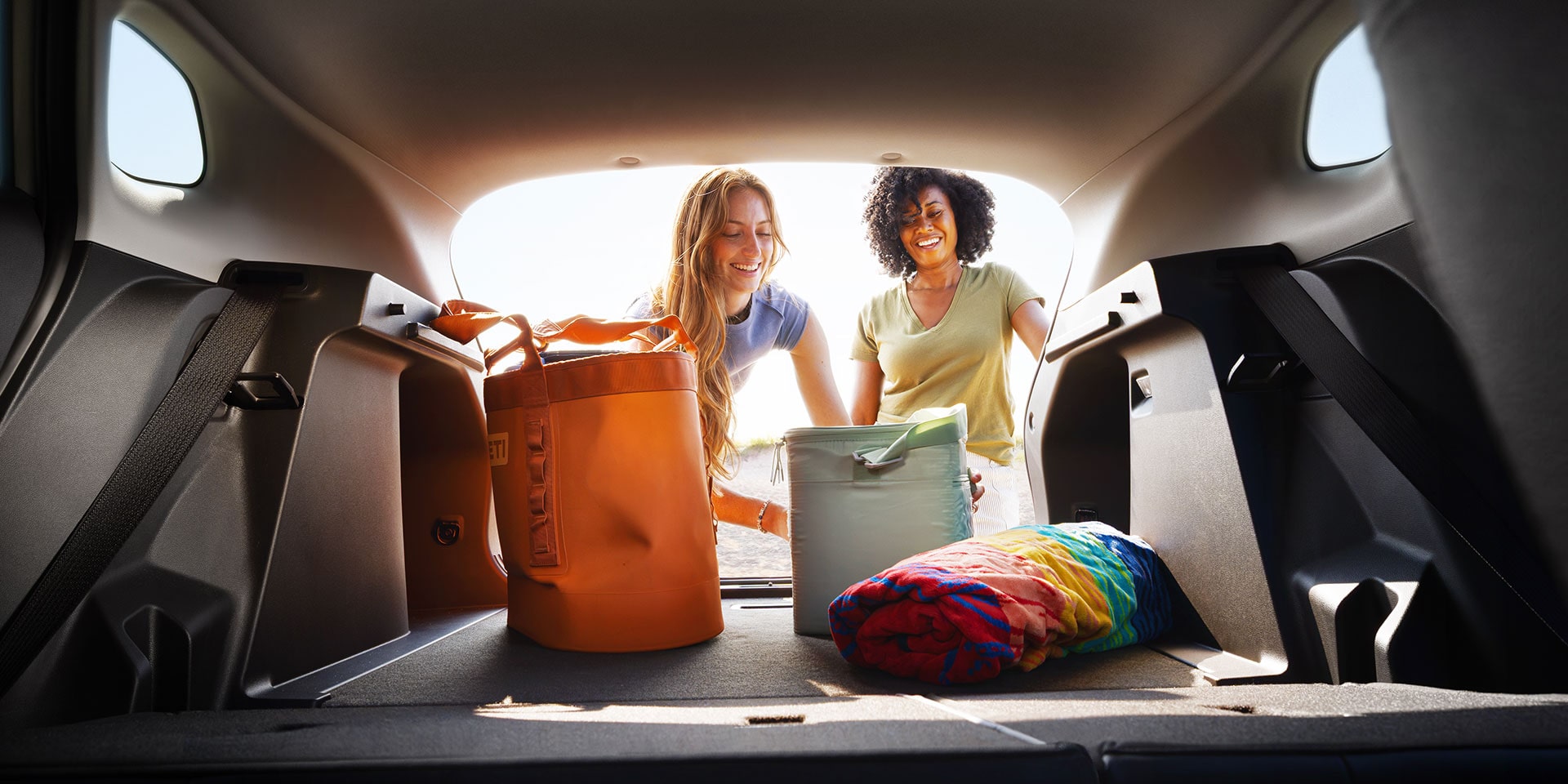 2027 Chevrolet Trax small SUV cargo area with rear seats folded and luggage stored in the spacious rear storage compartment.