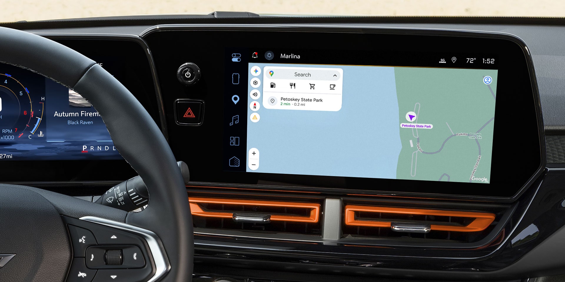 2027 Chevrolet Trax small SUV infotainment touchscreen displaying navigation with a digital driver display and orange-accented dashboard trim.