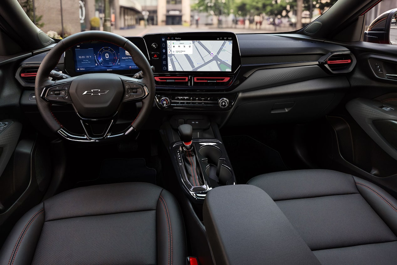 Interior of the 2027 Chevrolet Trax small SUV, highlighting the front seats, center console, steering wheel, digital instrument cluster, and touchscreen infotainment display.