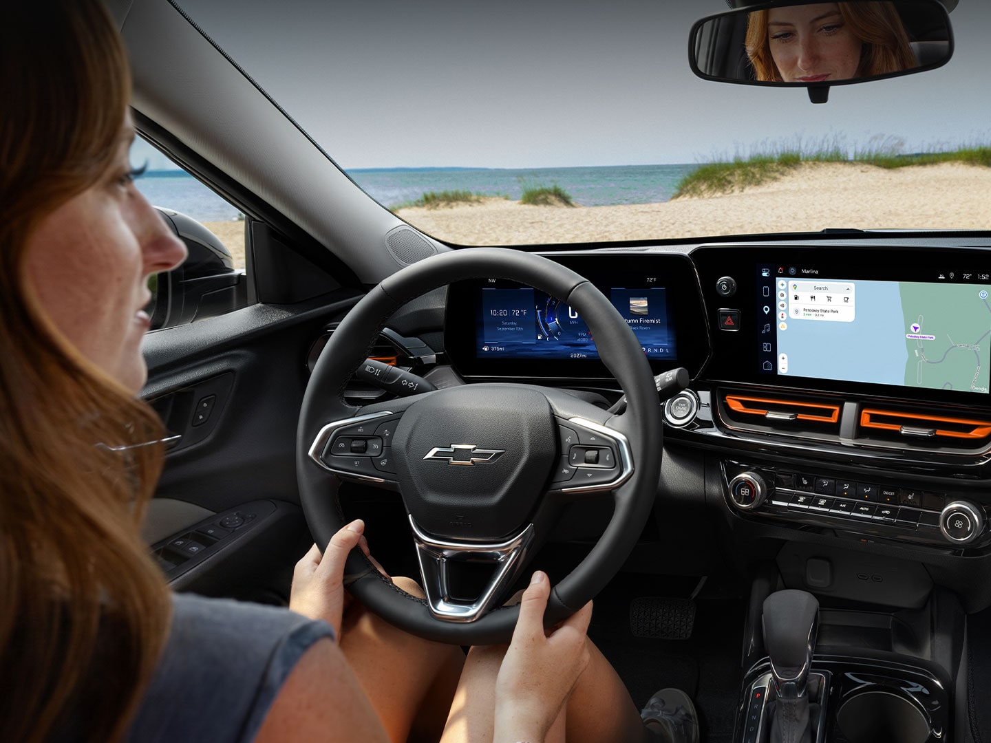Driver’s view inside the 2027 Chevrolet Trax small SUV, showcasing the steering wheel and digital driver display.