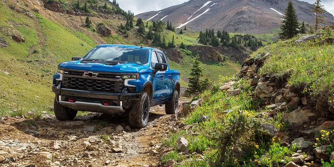 2022 Chevrolet Silverado 1500 driving on rough, inclined terrain.