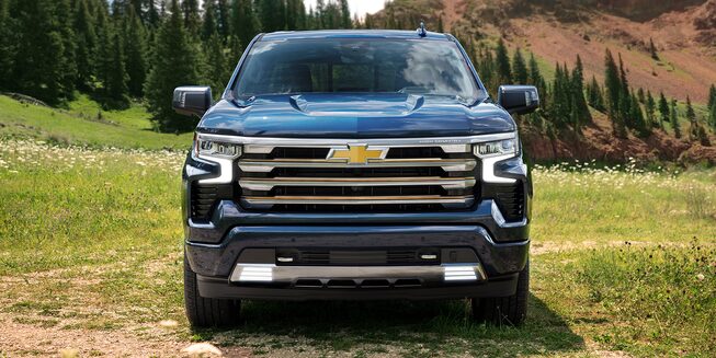 The New 2022 Silverado 1500 parked outdoors: front profile view.