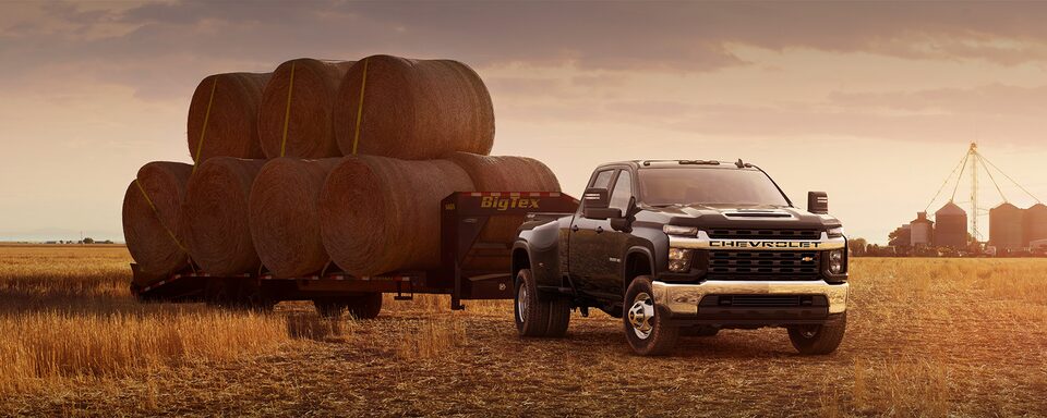 2023 Chevrolet Silverado HD towing bales of hay: Power to Pull Ahead.