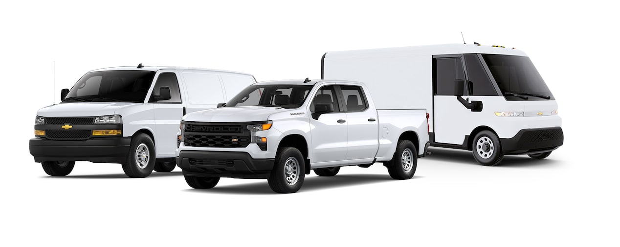 Three Chevrolet Commercial vehicles parked side by side each other.