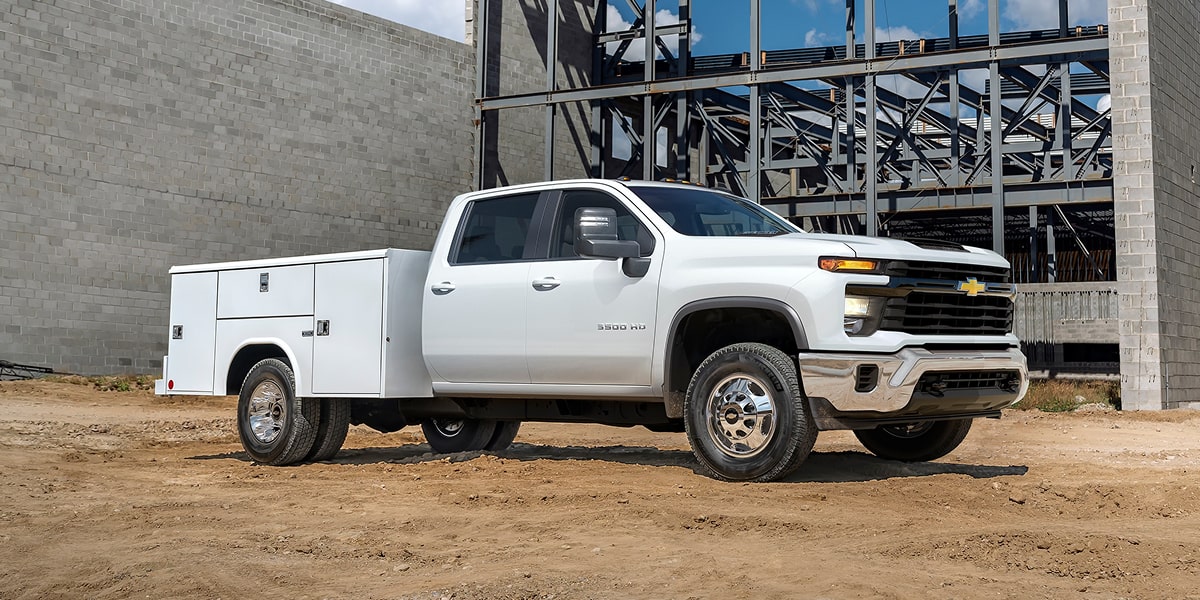 A 2026 Chevrolet Silverado 3500 HD Chassis Cab With a Utility Bed Parked at a Construction Site.