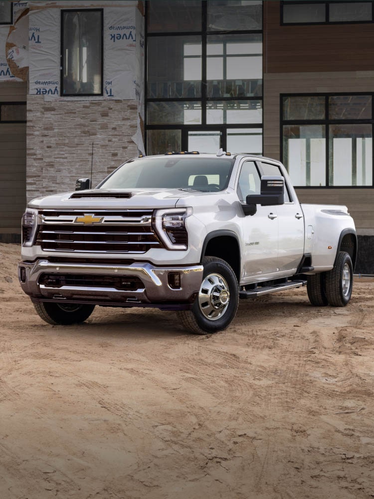 Front-side view of the 2026 Chevrolet Silverado HD Work Truck parked on a job site.