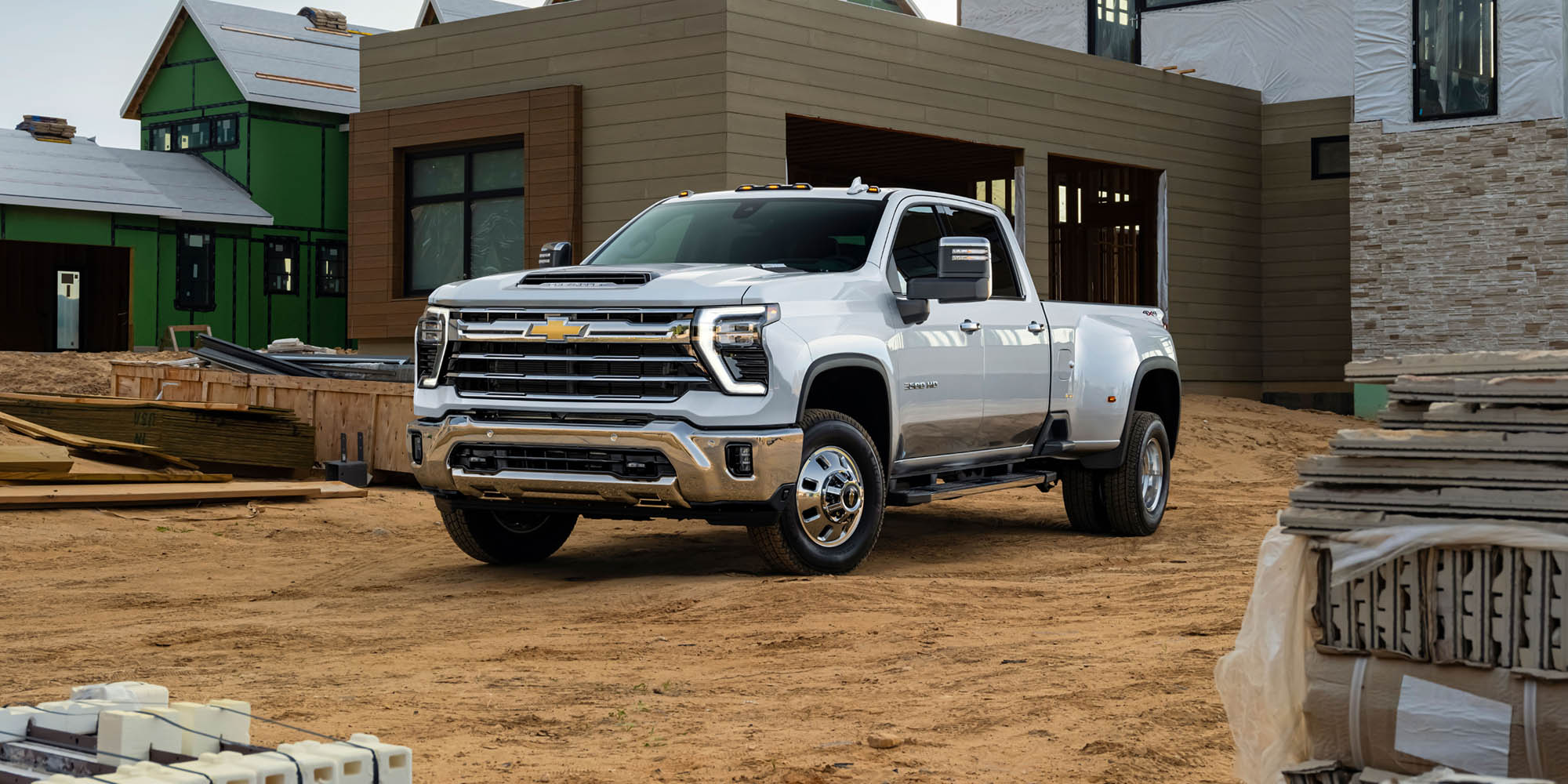 Front-side View of a 2026 Chevrolet Silverado HD Work Truck parked in Front of a House.