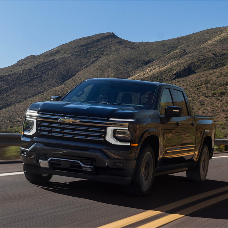 2027 Chevrolet Silverado 1500 High Country driving on a mountain road