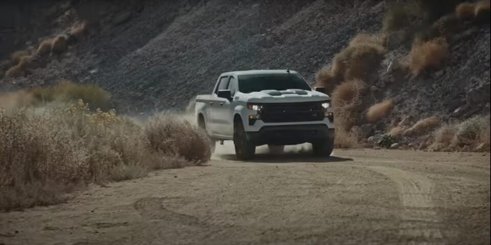 The 2024 Chevrolet Silverado making a swerve in a desert environment.