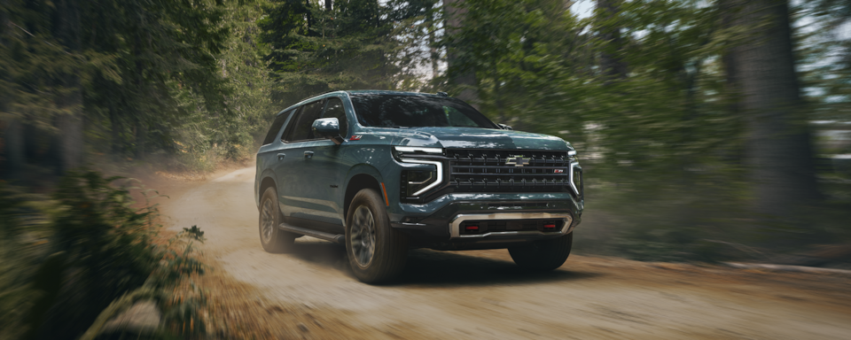 2025 Chevy Tahoe Driving Through a Forest Road